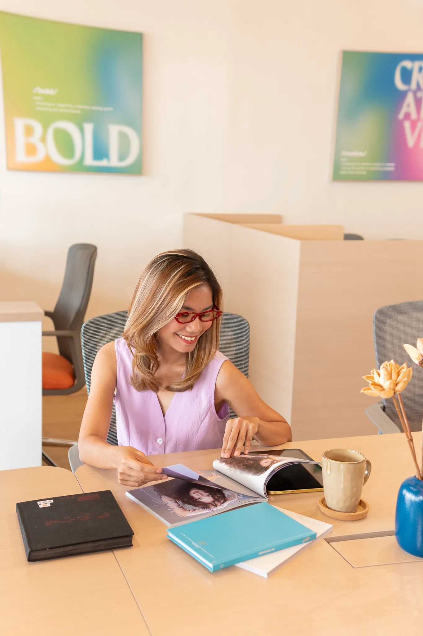 Business owner reviewing printed materials at a desk inside Mangoes and Bananas coworking space.
