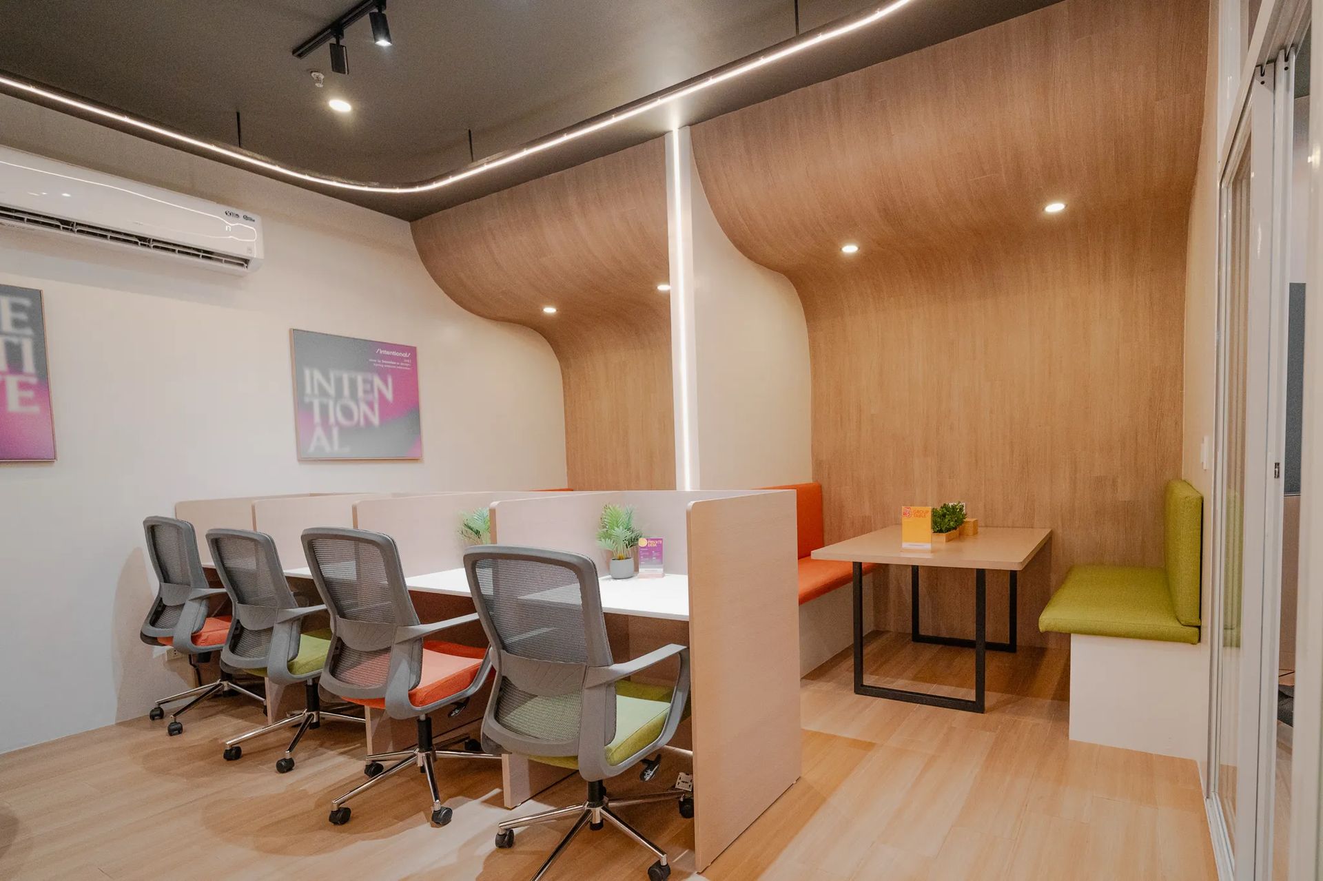 Shared desk area inside Mangoes and Bananas coworking space with chairs and lounge seating.