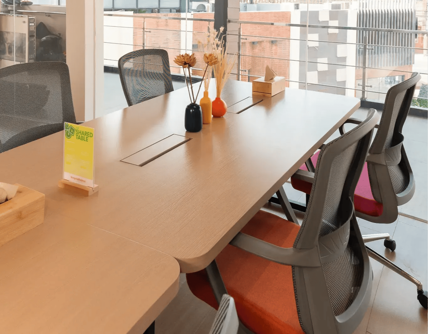 Long shared work table with chairs inside Mangoes and Bananas coworking space.