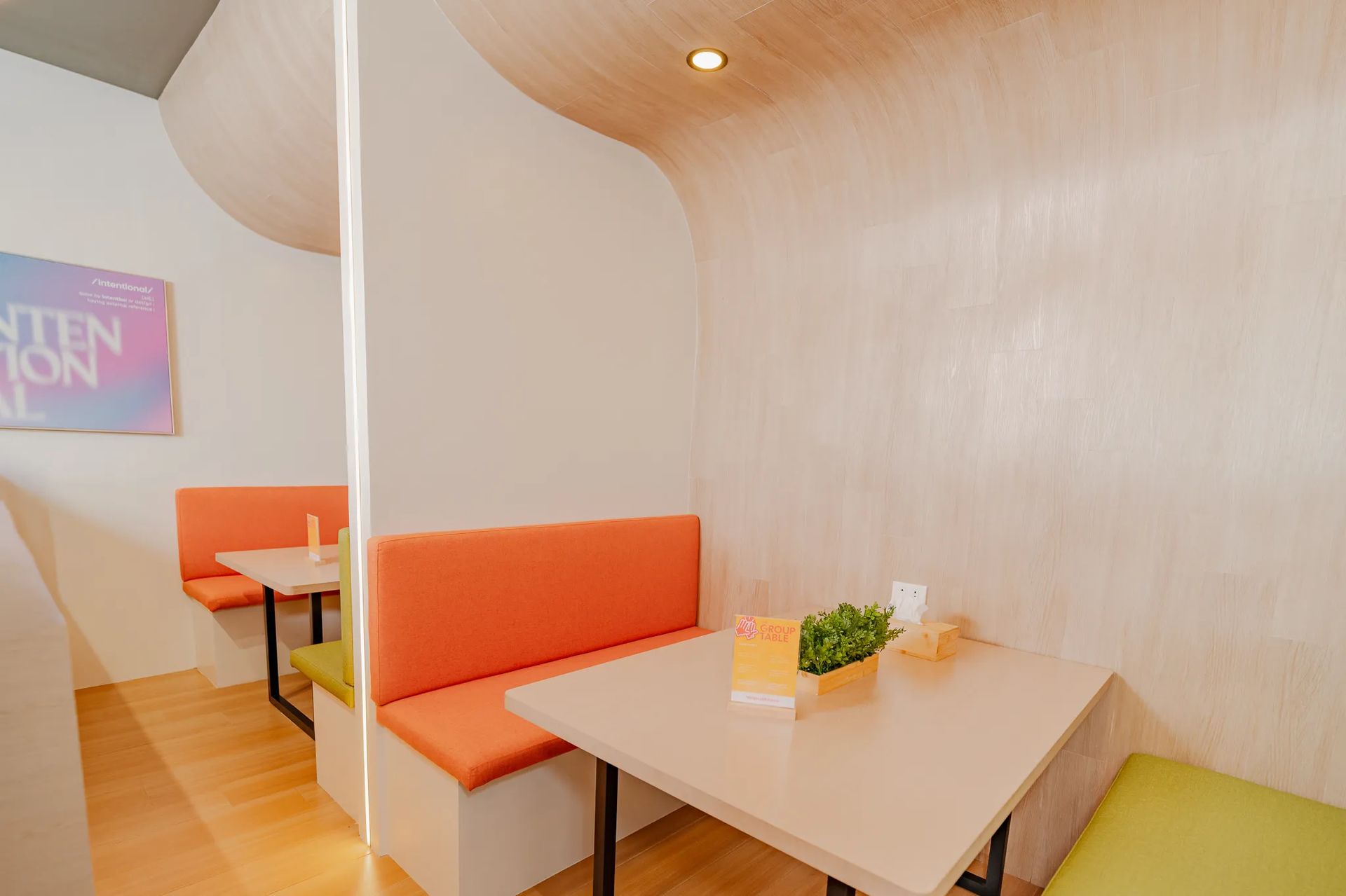 Booth seating area with table inside Mangoes and Bananas coworking space.
